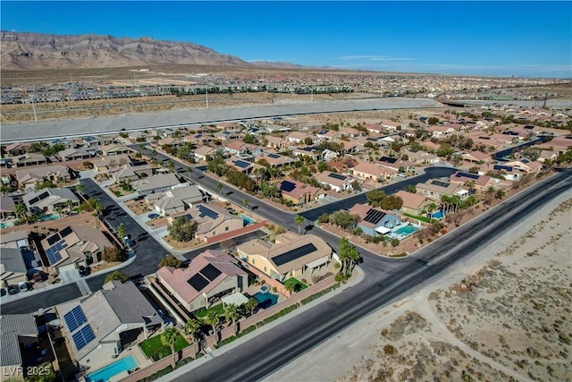 birds eye view of property with a mountain view