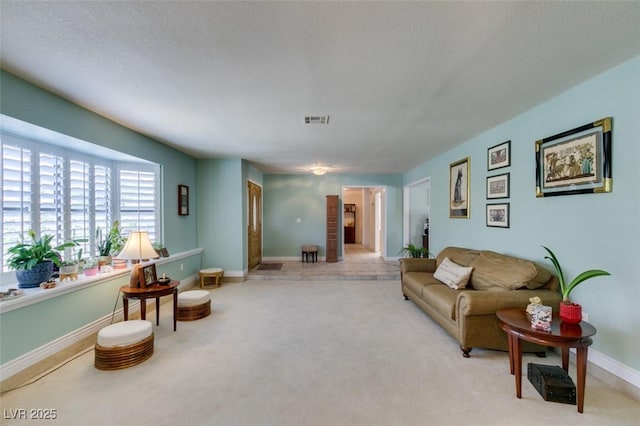 carpeted living room with a textured ceiling