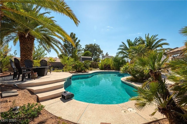 outdoor pool with a patio area