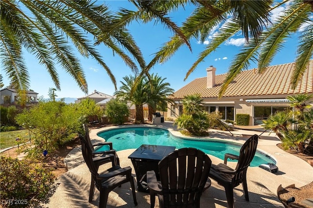 view of swimming pool with a patio and a fenced in pool