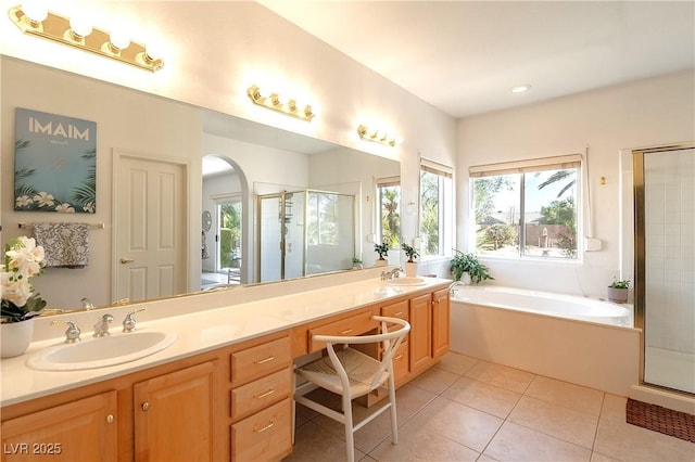 full bathroom with double vanity, tile patterned floors, a sink, a shower stall, and a bath