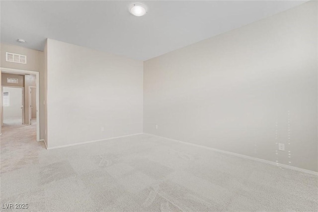 unfurnished room featuring light colored carpet