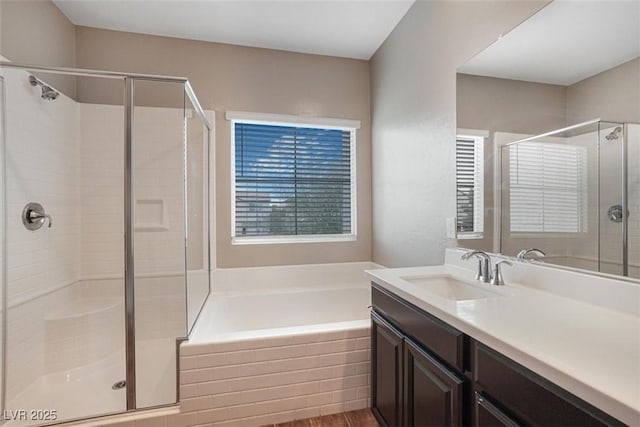 bathroom with vanity and separate shower and tub