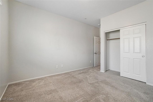 unfurnished bedroom with a closet and light carpet