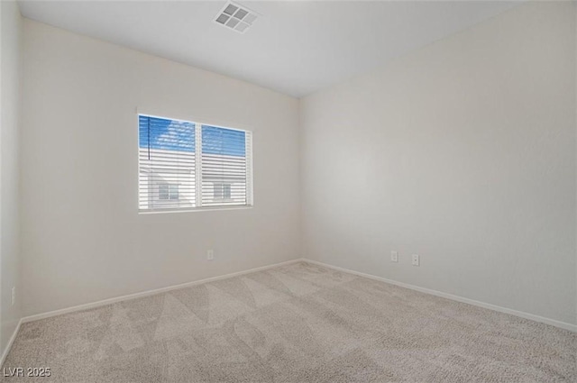 spare room featuring light colored carpet