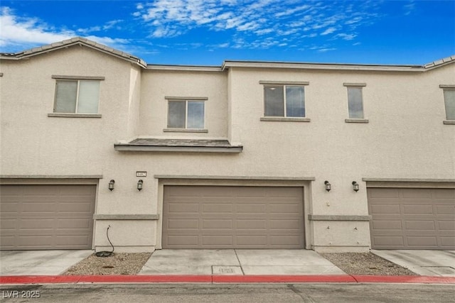 multi unit property featuring a garage