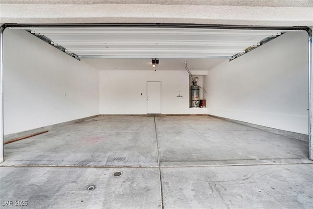 garage with a garage door opener and strapped water heater