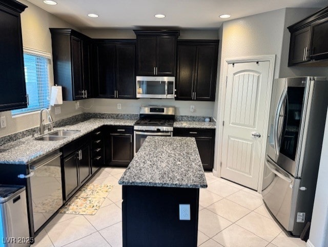 kitchen featuring a sink, stainless steel appliances, a kitchen island, and light tile patterned floors