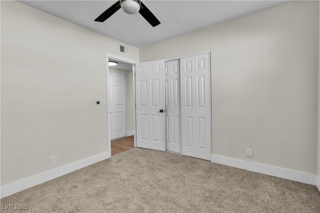 unfurnished bedroom featuring carpet, ceiling fan, and a closet