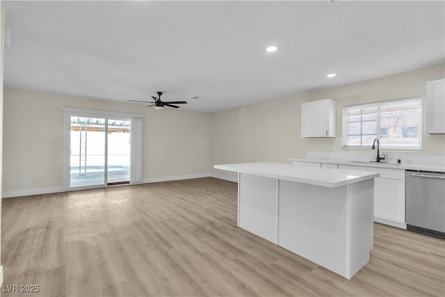 kitchen with white cabinetry, sink, a center island, and stainless steel dishwasher