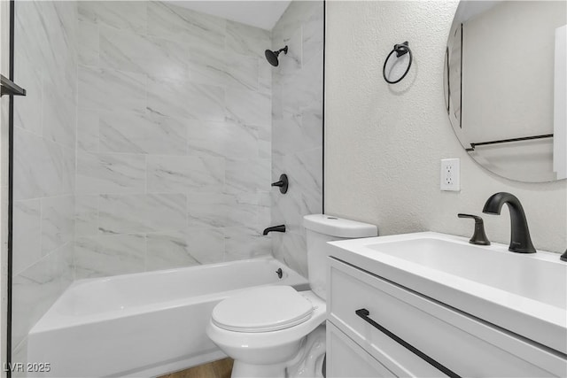 full bathroom featuring tiled shower / bath combo, vanity, and toilet