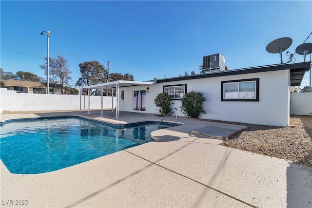 view of pool with central AC unit and a patio area