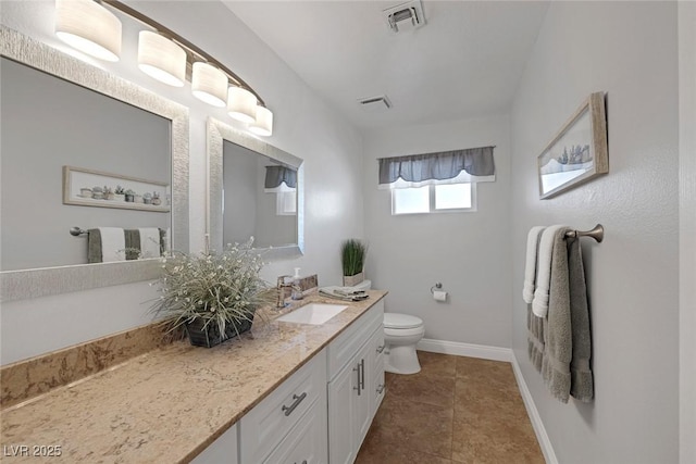 bathroom with tile patterned floors, vanity, and toilet