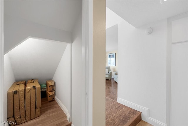 interior space featuring vaulted ceiling and light wood-type flooring