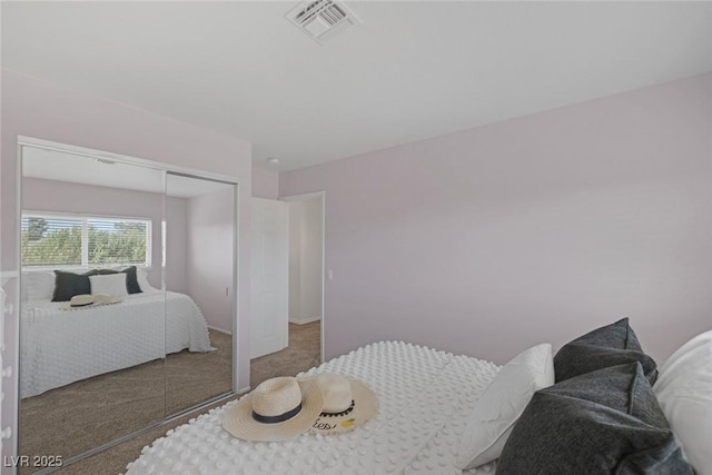 carpeted bedroom featuring a closet