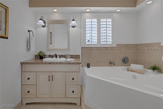 bathroom with vanity, tile patterned flooring, and a washtub