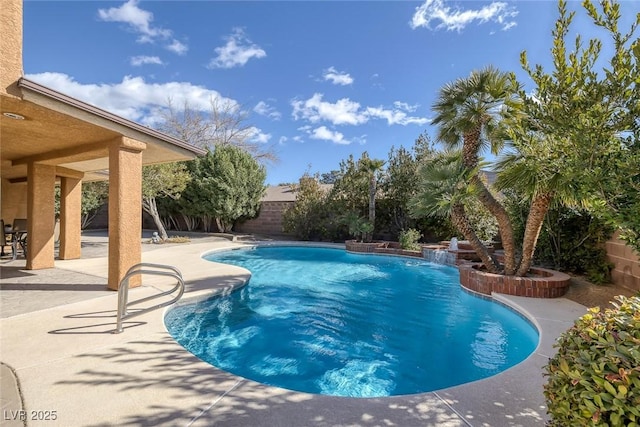 view of pool featuring pool water feature and a patio