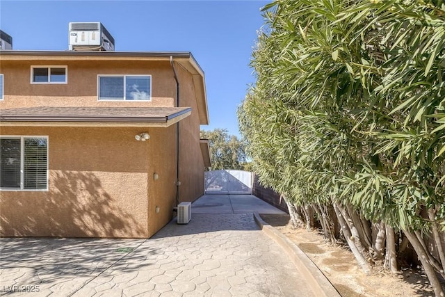 view of home's exterior with central AC unit and a patio area