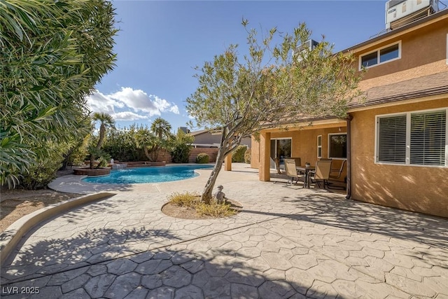 view of pool with a patio area and pool water feature