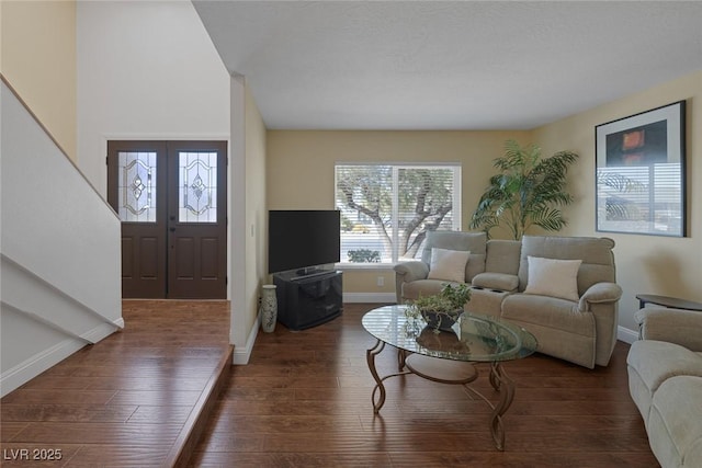 living room with french doors and dark hardwood / wood-style flooring