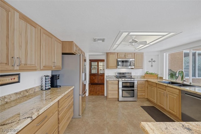 kitchen featuring ceiling fan, stainless steel appliances, sink, and light brown cabinets