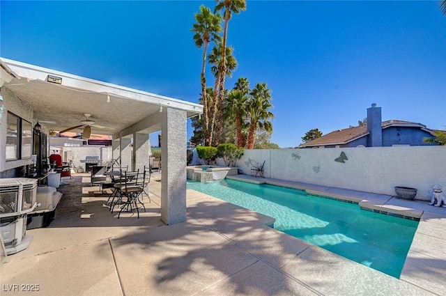 view of swimming pool featuring a patio, a pool with connected hot tub, a fenced backyard, and a ceiling fan