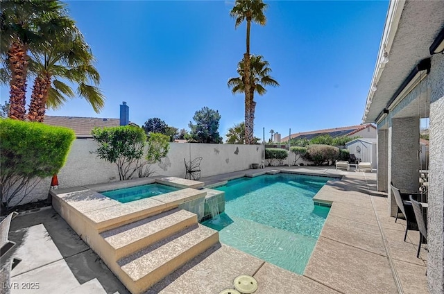 view of swimming pool with a patio, a fenced backyard, and a pool with connected hot tub