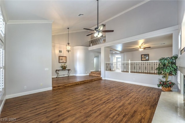 unfurnished living room featuring dark hardwood / wood-style flooring, crown molding, high vaulted ceiling, and ceiling fan