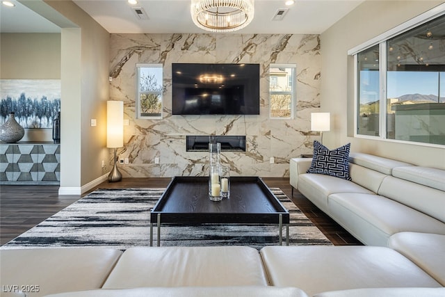 living room featuring a premium fireplace, wood finished floors, and recessed lighting