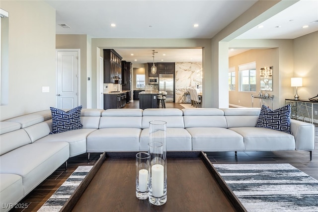 living room with dark wood-type flooring, recessed lighting, and visible vents