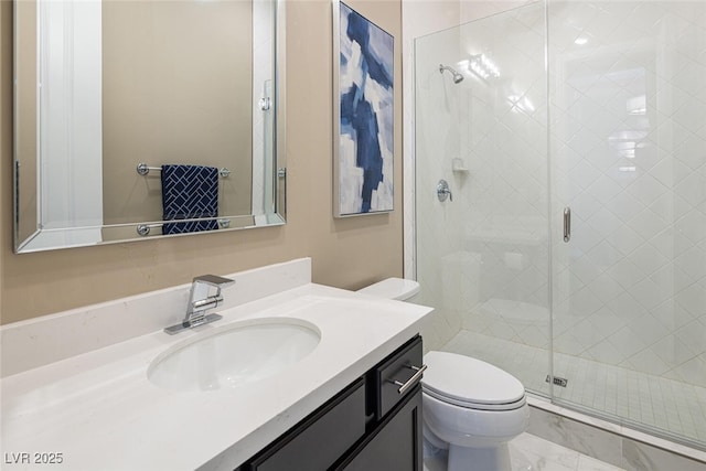 full bathroom featuring vanity, a shower stall, and toilet