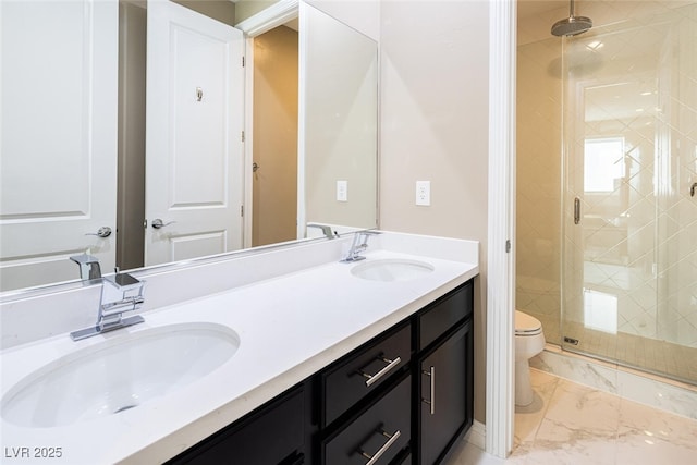 bathroom with marble finish floor, a sink, toilet, and a shower stall