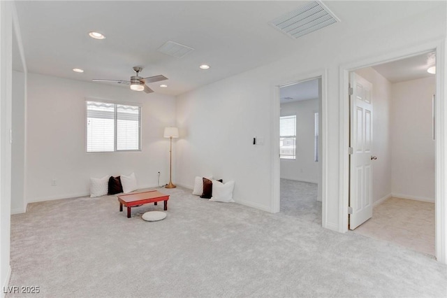 sitting room featuring light carpet and ceiling fan