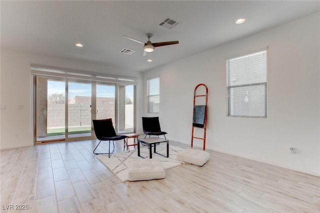 sitting room featuring ceiling fan and light wood-type flooring