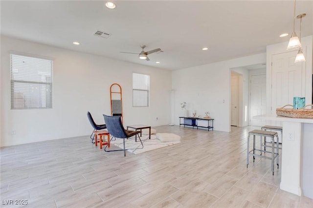 sitting room featuring light hardwood / wood-style floors and ceiling fan