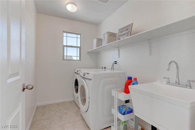 laundry room with separate washer and dryer and sink