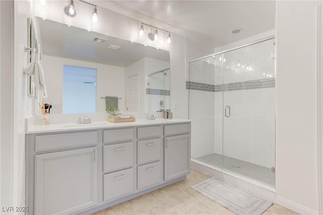 bathroom featuring vanity, an enclosed shower, and tile patterned flooring