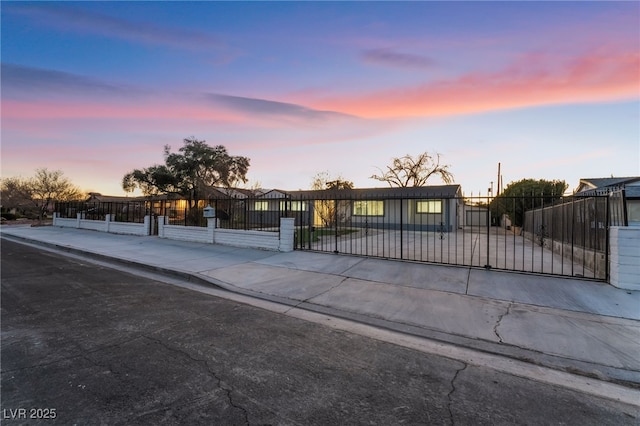 view of front of property with a fenced front yard and a gate