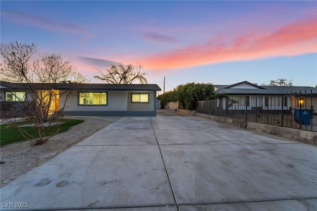 view of front facade with driveway and stucco siding