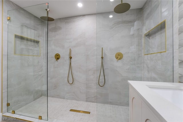 bathroom featuring a walk in shower, vanity, and tile walls