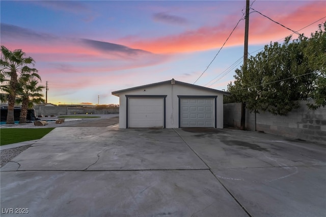 detached garage featuring fence