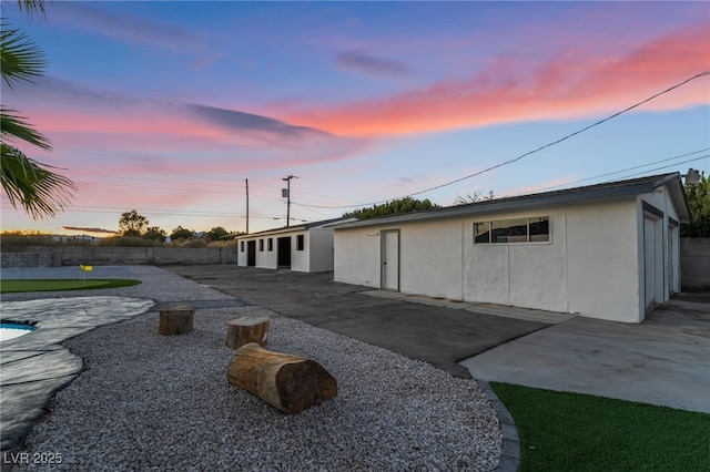 back of property with a patio area and stucco siding