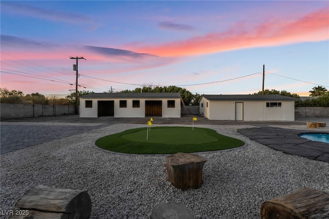 single story home featuring a fenced in pool, curved driveway, a patio, stucco siding, and fence