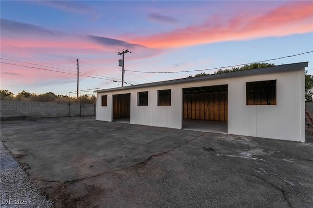 exterior space featuring an outbuilding and fence