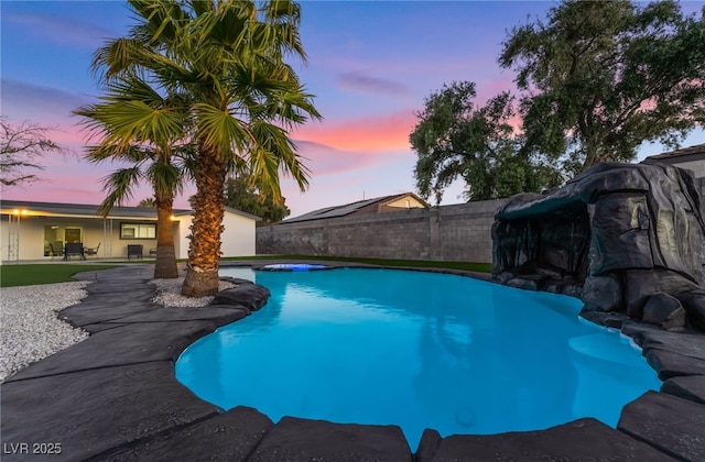 pool at dusk featuring a fenced in pool, a patio area, and fence