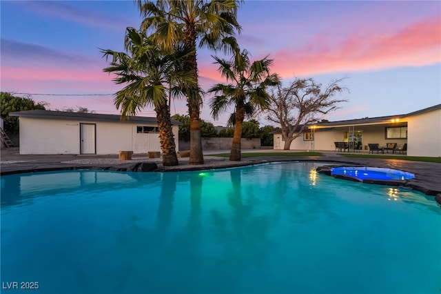 view of swimming pool with a pool with connected hot tub and a patio