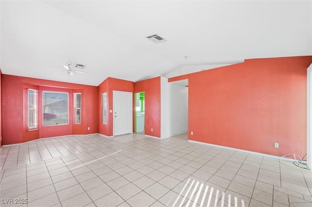 spare room featuring lofted ceiling, light tile patterned floors, and ceiling fan