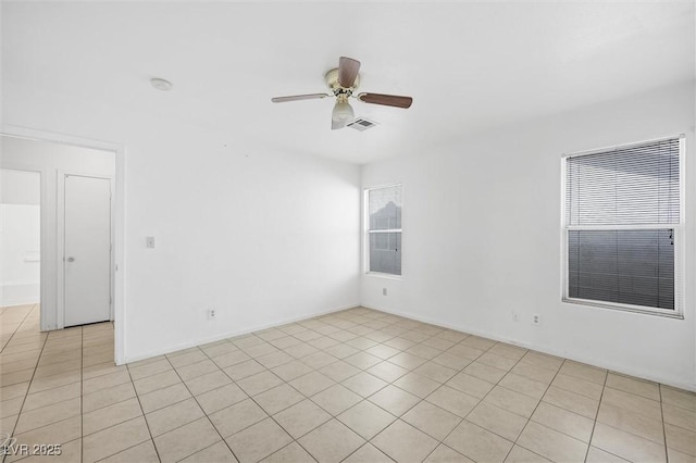 tiled spare room with ceiling fan