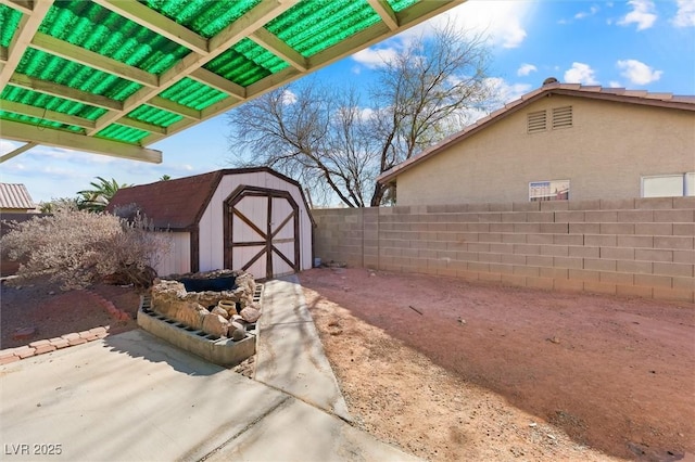 exterior space featuring a storage unit and a patio