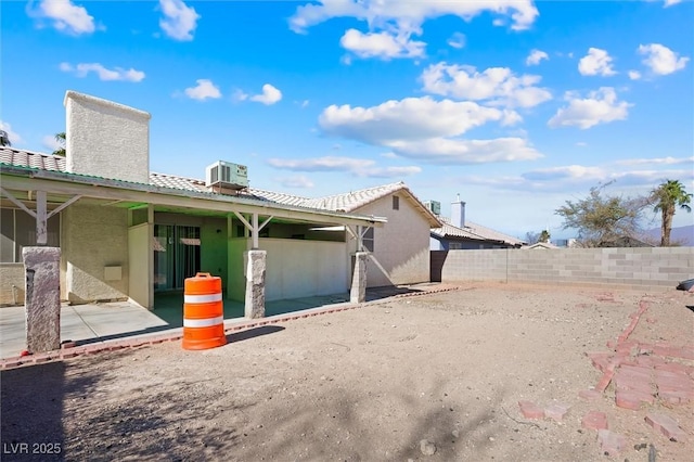 rear view of house featuring a patio and central AC